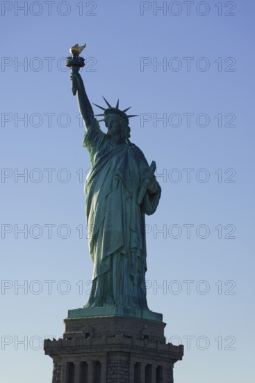 The Statue of Liberty in front of a clear blue sky, symbol of freedom and independence, on the East