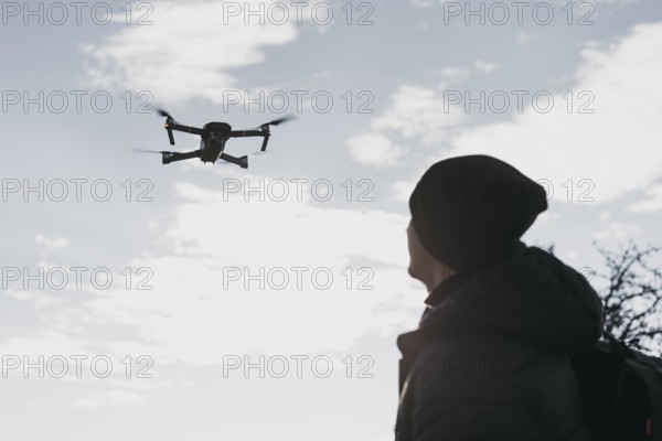 Low angle man watching drone
