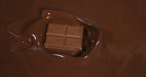 Chocolate tablet falling into Milk Chocolate