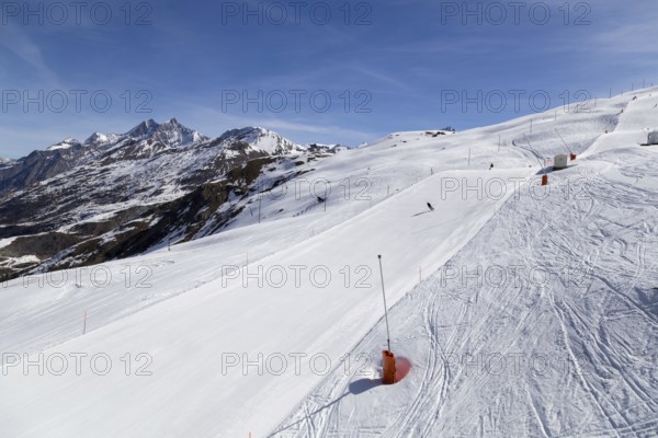 Zermatt, Switzerland, April 12, 2017: Unrecognisable people skiing on an almost empty ski piste in