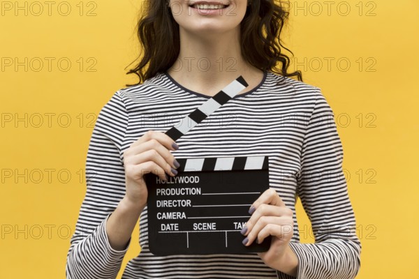 Woman director holding clapperboard