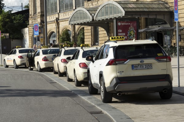 Taxis parked at a taxi rank in front of Dammtor train station in Hamburg, Germany, Europe