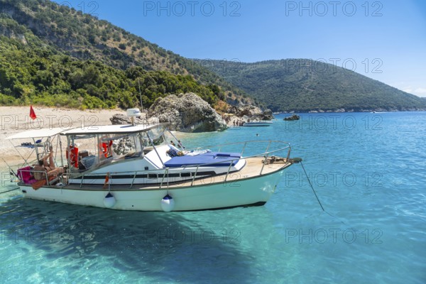 Boat in the transparent waters of the paradise beach of Kroreza or Krorez from the boat on the