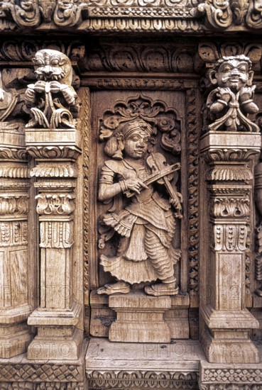 Playing Violin, 17th century wooden carvings in Meenakshi-Sundareswarar temple Chariot at Madurai,