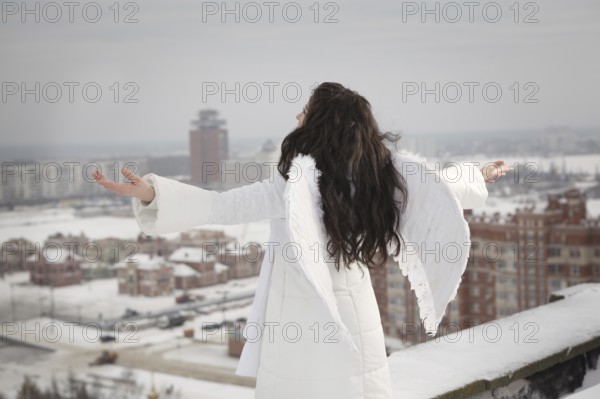 Angel on the roof in cold winter