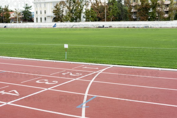Running track with grass field sunny day