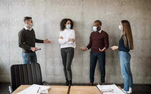 People with medical masks talking each other before meeting