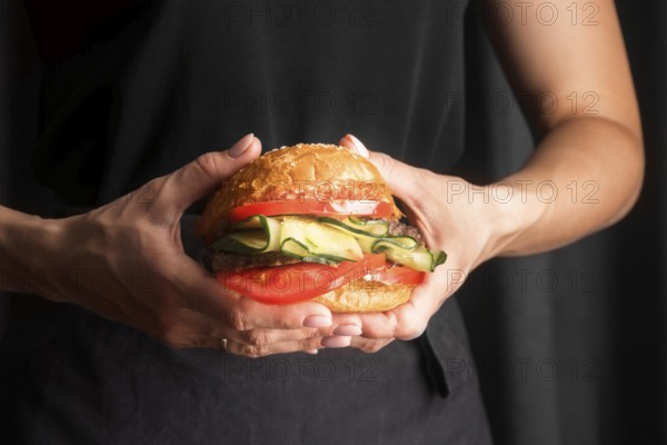 Man holding tasty hamburger