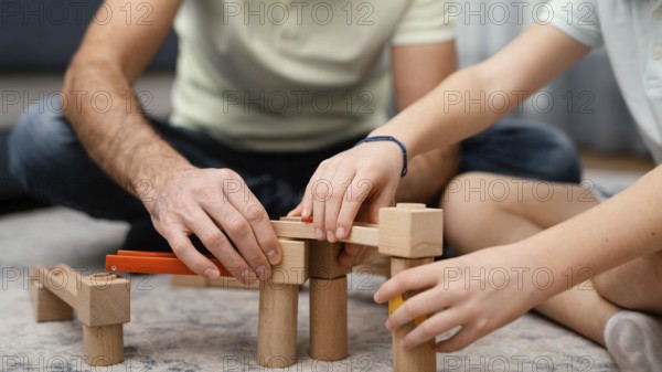 Father child playing with toys front view