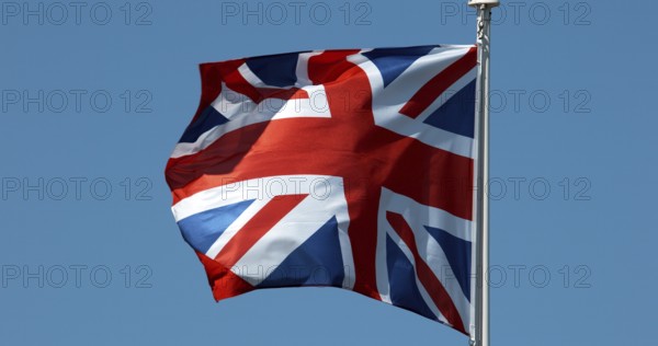 British Flag Waving in the Wind against blue sky