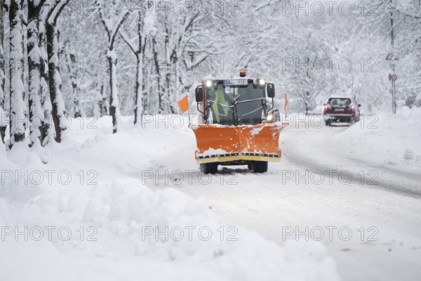Snow plough on a snow-covered road, Daglfing, Munich, Bavaria, Germany, Europe