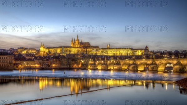 Prague, Czech Republic, March 15, 2017: Evening sunset view of Prague Castle and Charles Bridge,