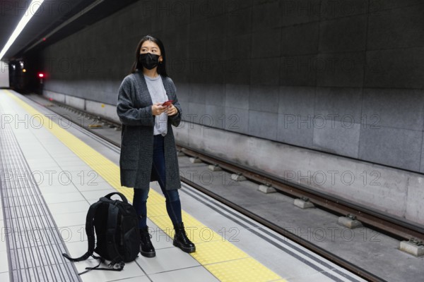 Young woman with mask subway station