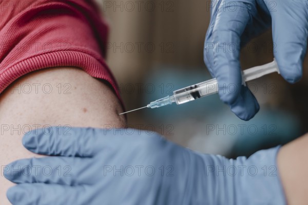 Doctor wearing gloves giving child vaccine