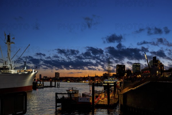 View from the Elbe promenade to the Landungsbrücken, museum ship Cap San Diego, blue hour with