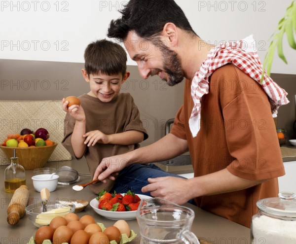Medium shot father kid cooking together