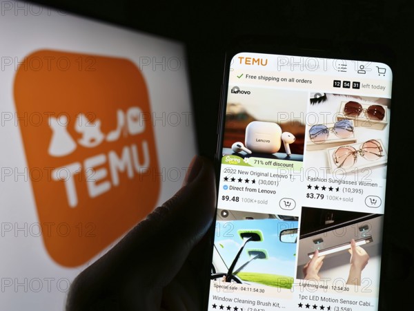 Stuttgart, Germany, 03-17-2023: Person holding cellphone with website of US online shop company