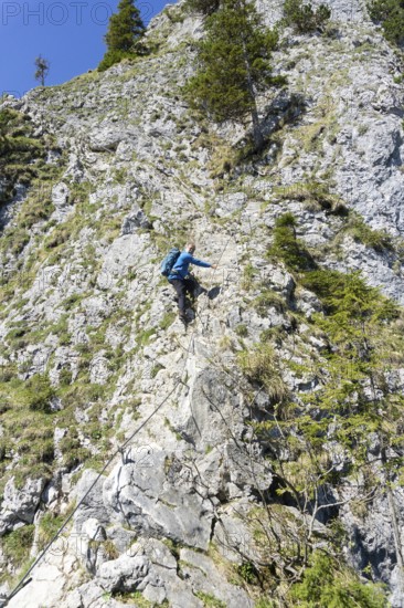 Climber, senior citizen, 66, climbing via ferrata on the Ettaler Mandl, Oberammergau, Ammergau