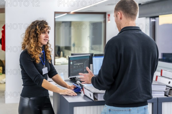 Two casual members of a hospital management talking in the office of the clinic