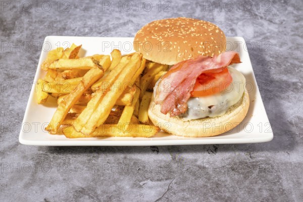 Hamburger plate with egg, bacon and french fries