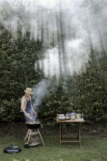 Man barbecuing in the garden