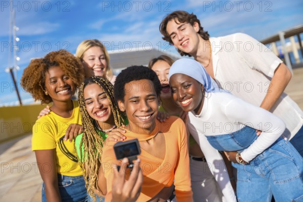 Frontal view of a transgender person talking a selfie with friends in an urban park