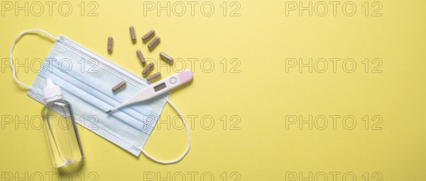 Top view medical mask with pills thermometer