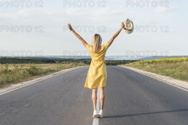 Back view blonde girl running middle street