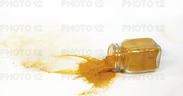 Turmeric (curcuma longa), Powder in a small Jar against White Background, Indian Spice