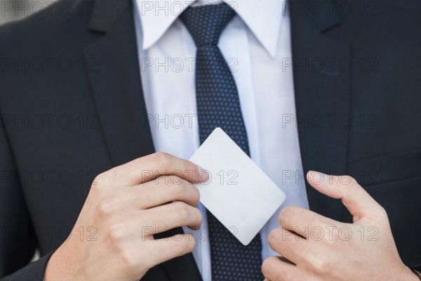Elegant businessman showing business card