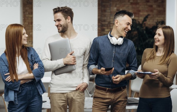 Smiley coworkers talking office