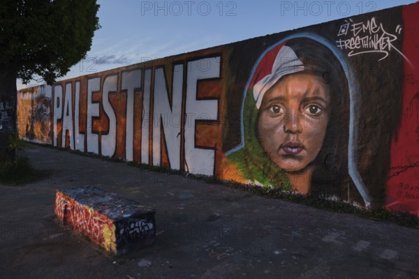 Germany, Berlin, 23. 05. 2021, Mauerpark, graffiti wall, head of a Palestinian child, flag as