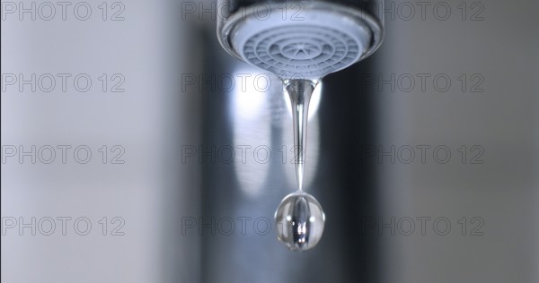 Water Flowing from the Tap, making a drop of water