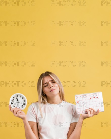 Woman holding clock menstrual calendar copy space