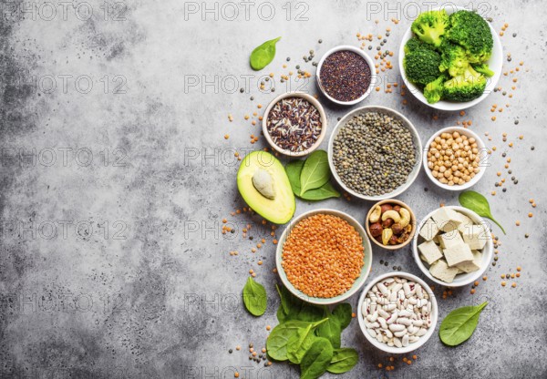 Variety of nutrient-rich food for vegans with copy space: beans, lentils, quinoa, tofu, vegetables,