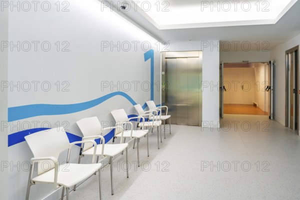 Waiting corridor with chairs in an hospital without people