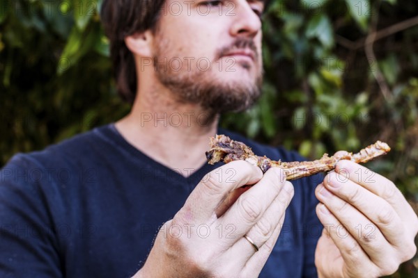 Close up man eating meat