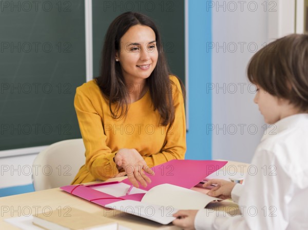Teacher talking with her student class