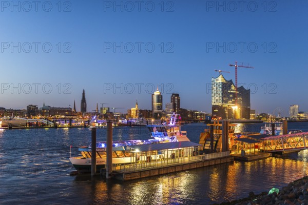 Night picture from the illuminated skyline of Hamburg at the Elbe river with the attractions Elbe