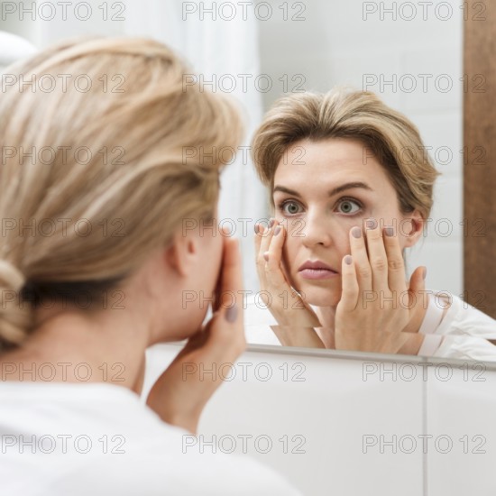 Woman checking her eyes mirror