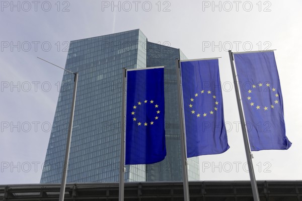 The new European Central Bank, ECB, European flags fly in front of a modern high-rise building with