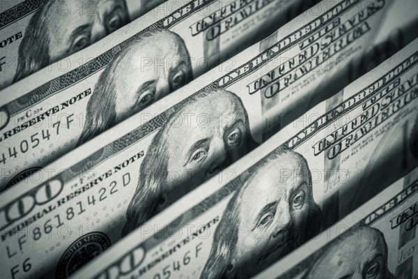 Hundred dollars bills standing in a row. Selective focus