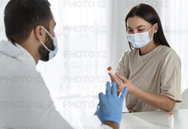 Woman with medical mask talking doctor