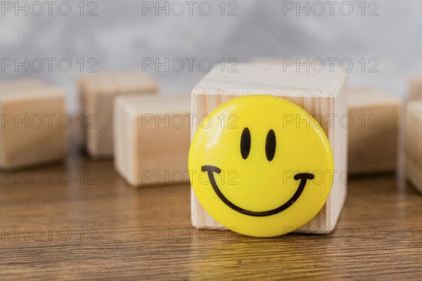 Front view smiley face wooden block. High resolution photo