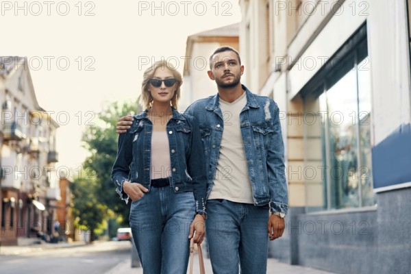 Beautiful young couple walking on the street. Love, travel, fashion and date concept