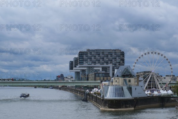 View over the Rhine with crane houses and Ferris wheel, Cologne, Germany, Europe
