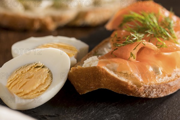 Close up sandwich slate with salmon hard boiled egg