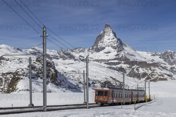 Zermatt, Switzerland, April 12, 2017: The red Gornergrat Train in front of the snowy Matterhorn