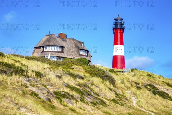Lighthouse and thatched-roof villa of the Kersig estate in the dunes, Hörnum, Sylt