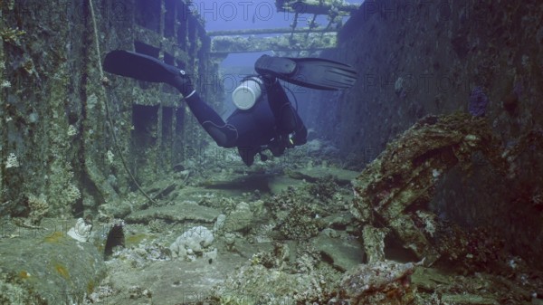 Scuba diver swim down corridor of ferry Salem Express shipwreck, Red sea, Safaga, Egypt, Africa